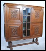 A large early 20th century carved oak bookcase cabinet of believed Flemish origin. Raised on