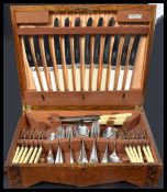 A 1930's canteen of cutlery having a hinged centre with appointed interior complete with canteen
