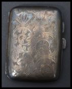 A silver hallmarked cigarette case with chased decoration hallmarked for Chester by E J Trevitt &
