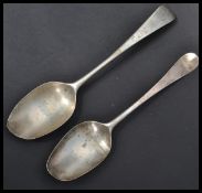 An 18th century Georgian silver table basting spoon by James Wilks (1742..1755) along with another