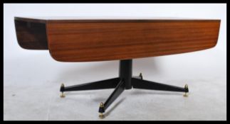 A rare G-Plan E Gomme metamorphic coffee / dining table with drop leaves to the side. Raised on a
