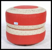 A retro mid century two tone vinyl panel stitched pouffe, having a geometric design to the top and