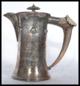 A silver plated vintage 20th century Arts and Crafts pewter coffee pot mounted with a horn handle to