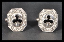 A pair of sterling silver cuff links cuffs of octagonal form having black enamel decoration of