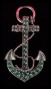 A sterling silver brooch / pendant in the form of an anchor with inset green stones complete in