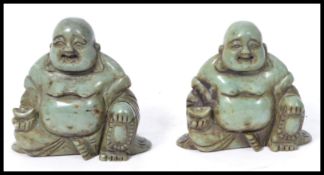 A pair of early 20th century carved soapstone Chinese laughing Buddha 's holding pots. Jade green