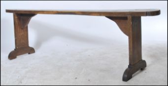 A   19th century French refectory pig bench. The bench with shaped single plant tops of fruitwood