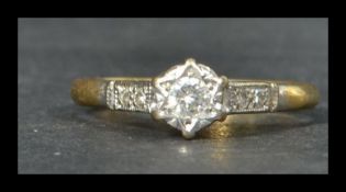 A hallmarked 18ct gold platinum and diamond ring having diamond set shoulders and illusion set