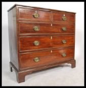 A 19th century Georgian mahogany chest of drawers having brass drop handles with brass flower back