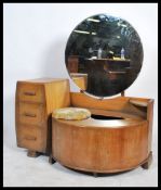 A 1930's Art Deco oak dressing table chest. The dressing table with comma shaped swing out stool