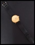 A vintage 20th century Omega Constellation swiss made wrist watch. The gilt dial having baton and