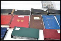 A large collection of vintage 20th century FDCs first day cover stamps held within 12 albums. Many