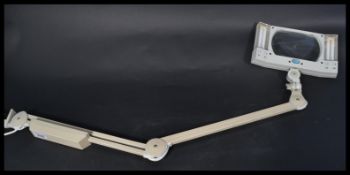 A Luxo adjustable illuminated magnifying  desk - clamped medical / watch makers work lamp