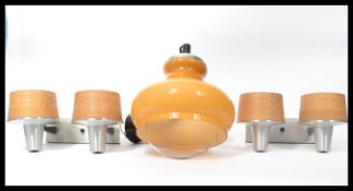 A retro vintage pair of twin conical wall sconces formed for aluminium with spun strip shades