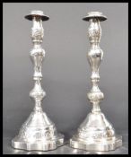 A pair of early 20th century silver hallmarked Jewish Judaica Sabbath candlesticks raised on