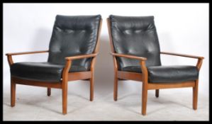 A pair of vintage / retro open framed armchairs / lounge chairs, upholstered in a black