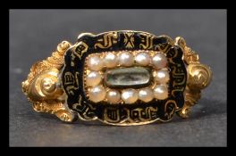A hallmarked 18ct gold Georgian black enamel and pearl mourning ring. The ring having a