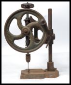 A vintage  early 20th Century Bradson cast iron bench drill model number 1 mounted on heavy base