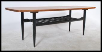 A mid century teak vintage / retro long  coffee table raised on tapered ebonised legs. Measures: