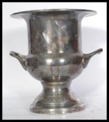 An Elkington silver plated wine cooler / champagne bucket raised on a stepped circular base with