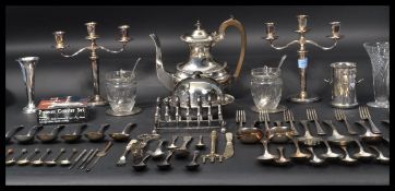 A good collection of silver plate to include coffee pot , toast rack , trumpet vase , various sets