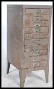 A vintage / retro industrial upright metal eight short drawer filing cabinet, shaped supports having