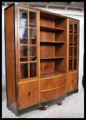 A large 1930's Art Deco mahogany / walnut bookcase with ebonised flashwork. Raised on plinth base