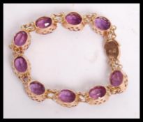 A superb vintage 14ct gold and synthetic alexandrite / colour change sapphire bracelet being set