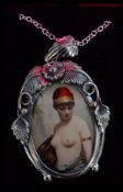 A sterling silver necklace chain with silver pendant having a ceramic semi nude porcelain plaque