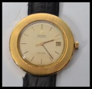 An 18ct gold Omega De Ville watch having an over sized waterproof case.The signed champagne dial