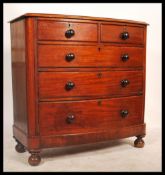 A Victorian mahogany bow front chest of drawers. Being raised on turned legs with a 2 short over 3
