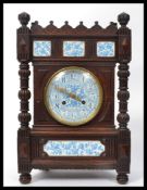 A 19th century oak cased French mantle clock having blue and white ceramic panels and face with gilt