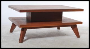 A 1970's retro teak wood Danish influence two tier coffee table. Each tier raised on angular legs