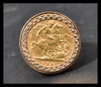 A 1897 Victoria half sovereign set within a plain 9ct gold mount, size ?? and a total weight of 10.