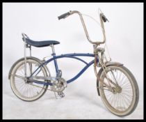 A vintage style single speed beach cruiser push bike / bicycle in the manner of a Schwinn Stingray