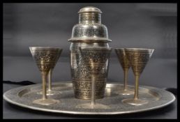 A mid century silver plated cocktail - drinks set in the manner of Siam silver. The ebonised