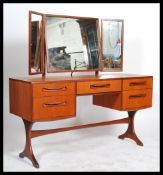 A 1970's G-Plan teak wood dressing table in the manner of Mogens Kolo. The dressing table raised