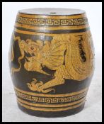 A 20th century Chinese ceramic opium stool having yellow decoration depicting dragons chasing the