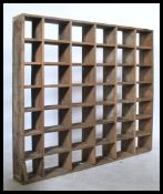 A mid century Industrial rustic wooden pigeon hole cubb cabinet having a series of 42 recess