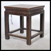 A 20th Century MinGuo period Chinese opium stool in elm wood. The stool table raised on squared legs
