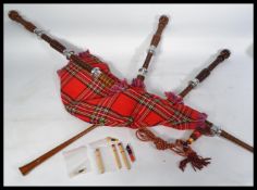 A set of bagpipes having turned column drones with chrome metal mounts. Complete with  blowstick and