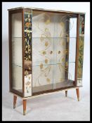 A 1930's display cabinet having a lined interior with fitted shelves, central astragal glazed door