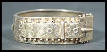 An early 20th Century Edwardian silver hallmarked hinged bracelet with hidden clasp in the form of a