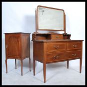 An Edwardian mahogany inlaid dressing table chest. Raised on square tapered legs with ceramic