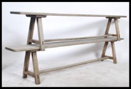 A pair of 19th century French country oak pig benches - garden benches. Each raised on angled legs