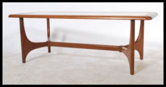 A retro 1970's teak wood long John coffee table with inset glass top with exposed panel under tier /