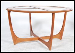 A 1970's G-Plan Atomic style coffee table of circular form raised on space age style supports with 4