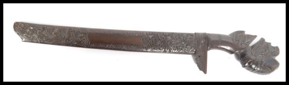 A vintage 20th century carved hardwood short sword. Shaped handle in the form of a goddess with