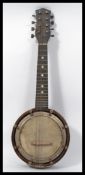 An early 20th century banjo Mandolin. The circular body having 8 strings to the neck with inset