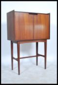 A stunning mid century Richard Hornby teak / Afromosia drinks cabinet / cocktail cabinet raised on